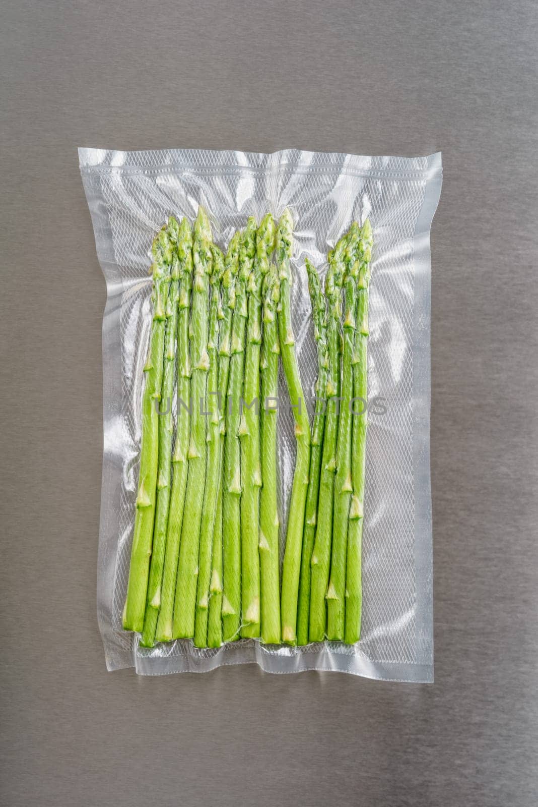 Green asparagus sealed in an airtight plastic bag ready for sous vide cooking