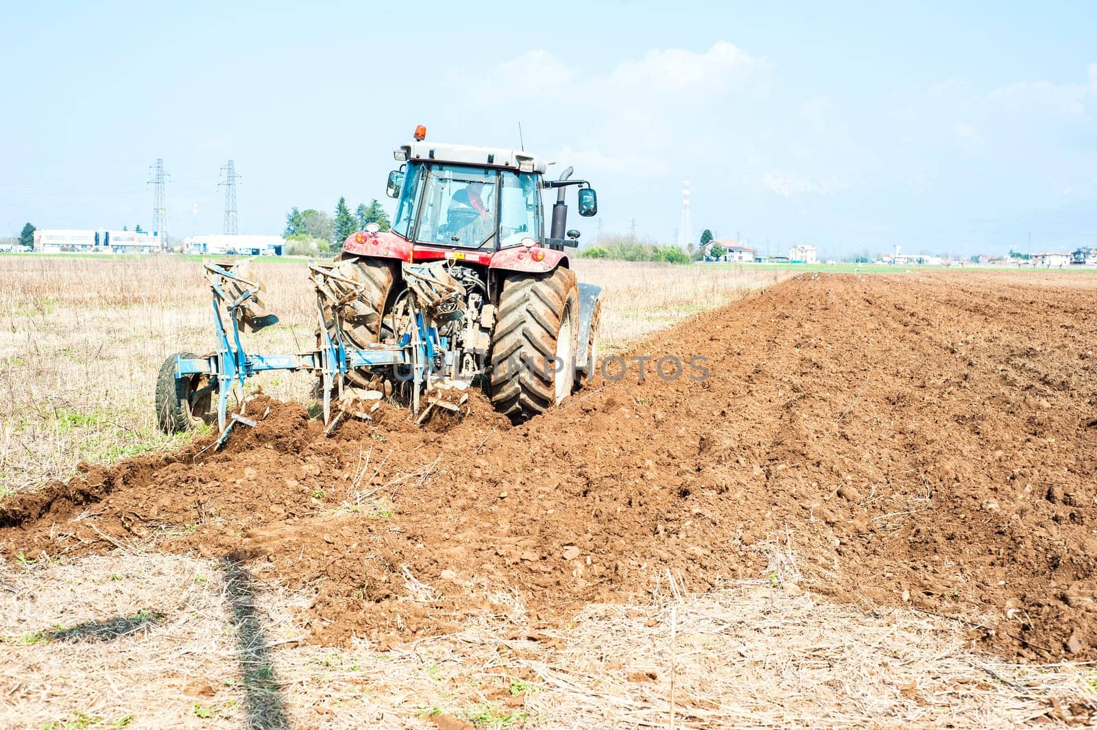 Agricultural work.  Tractor plowing the stubble field