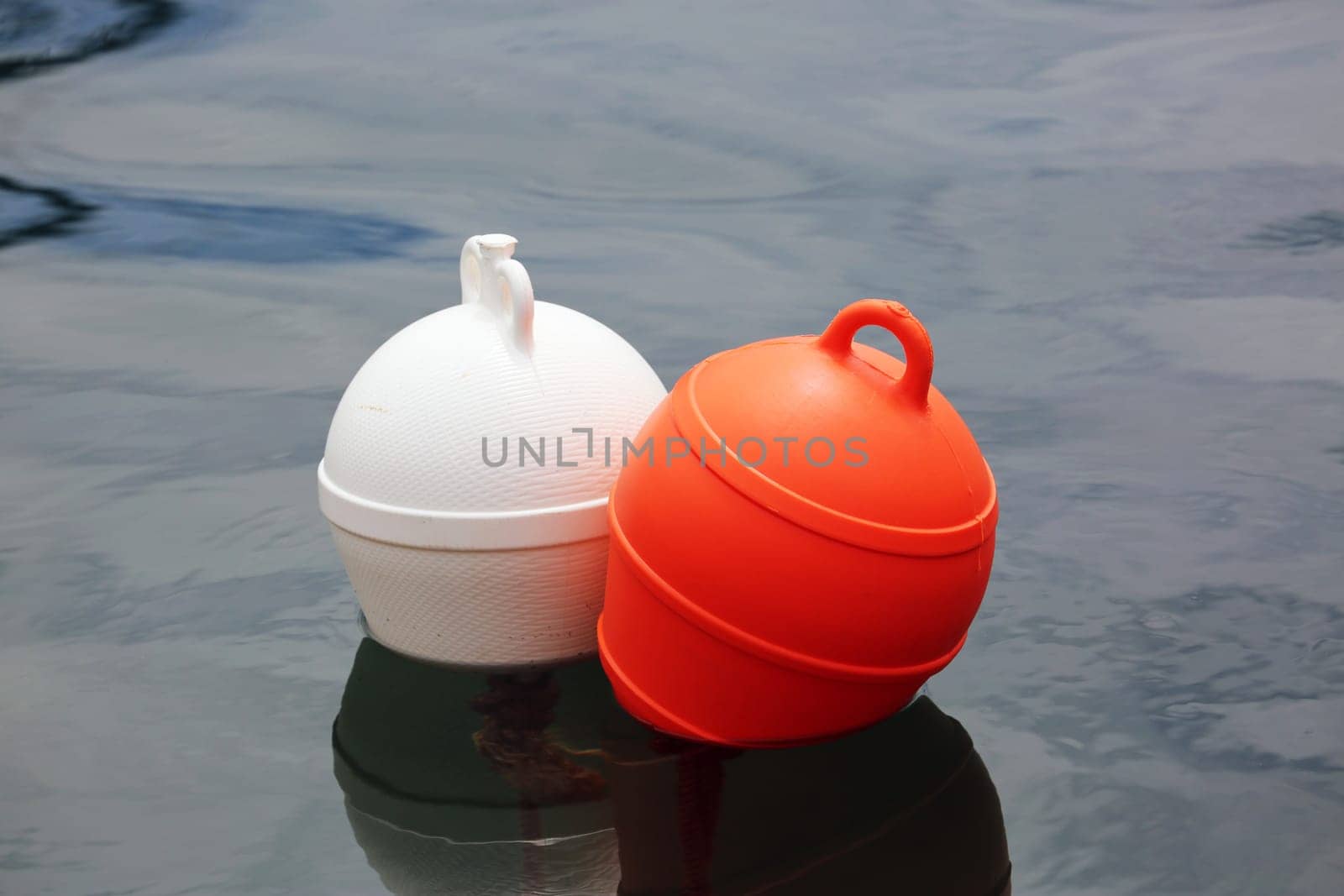 Orange And White Buoys in the Sea.