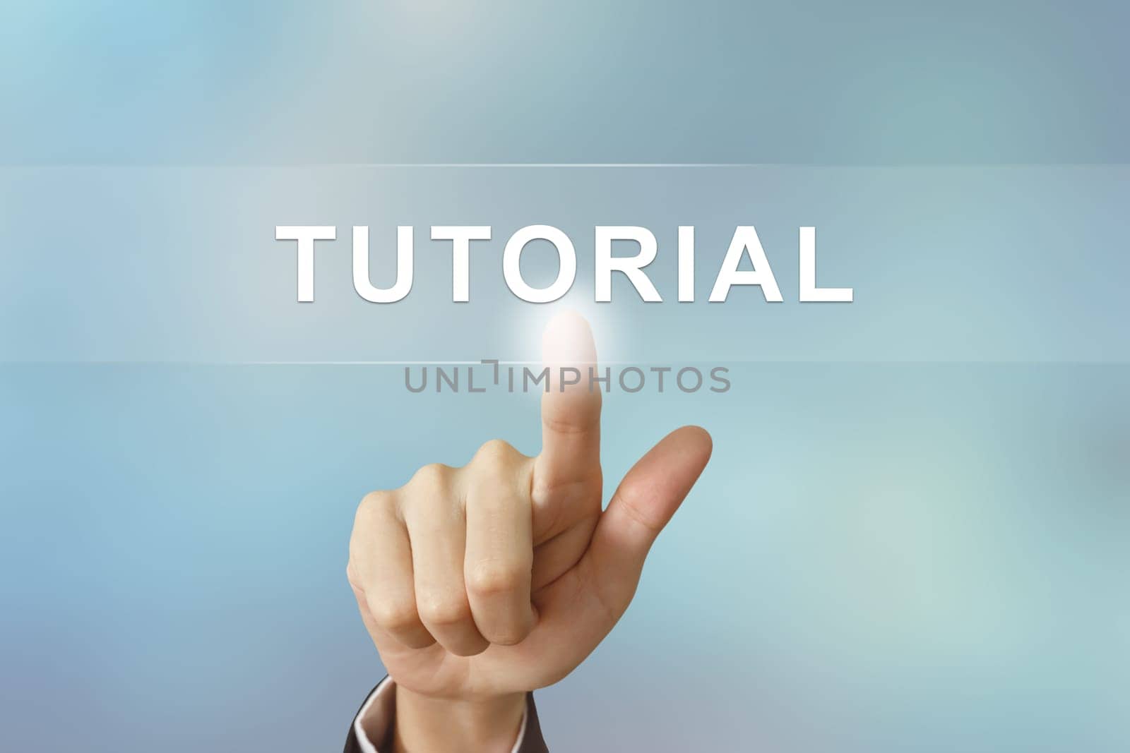 business hand pushing tutorial button on blurred background