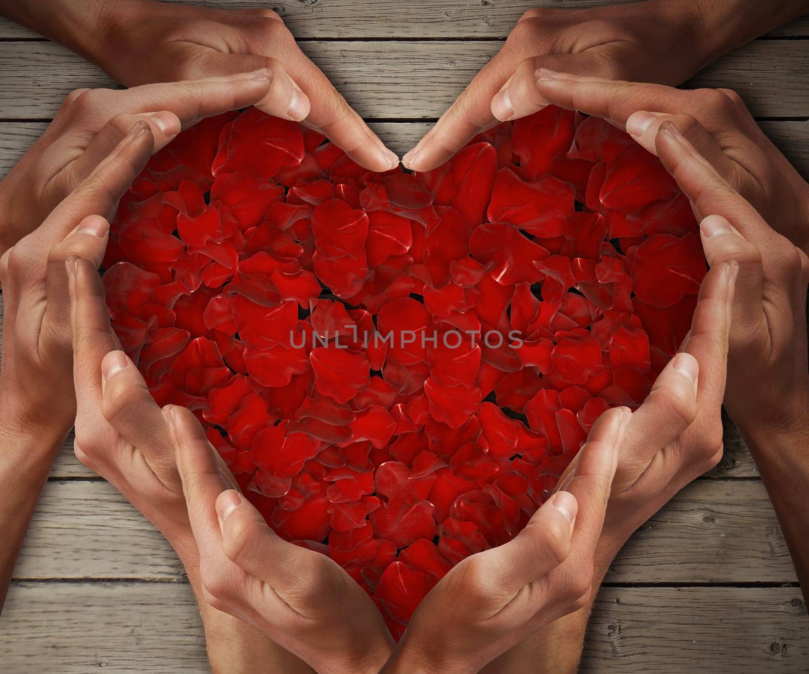 Man hands arranged in a heart shape with rose petals in center on a wooden table. Love concept