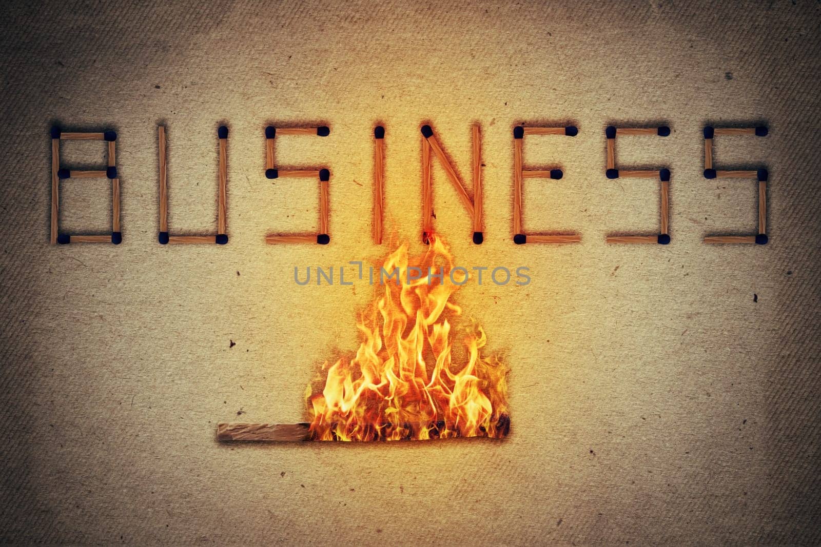 Burning match setting fire to its neighbors in arranged in shape of business word. Ignited match stick  as a symbol for business risks and dangers.