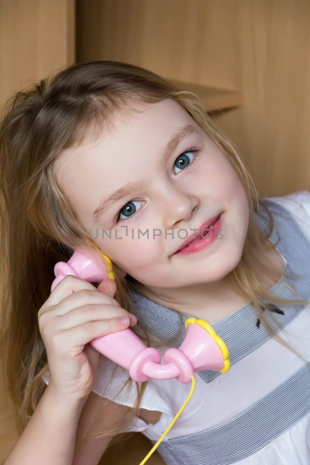 Portrait of beautiful girl with pink telephone