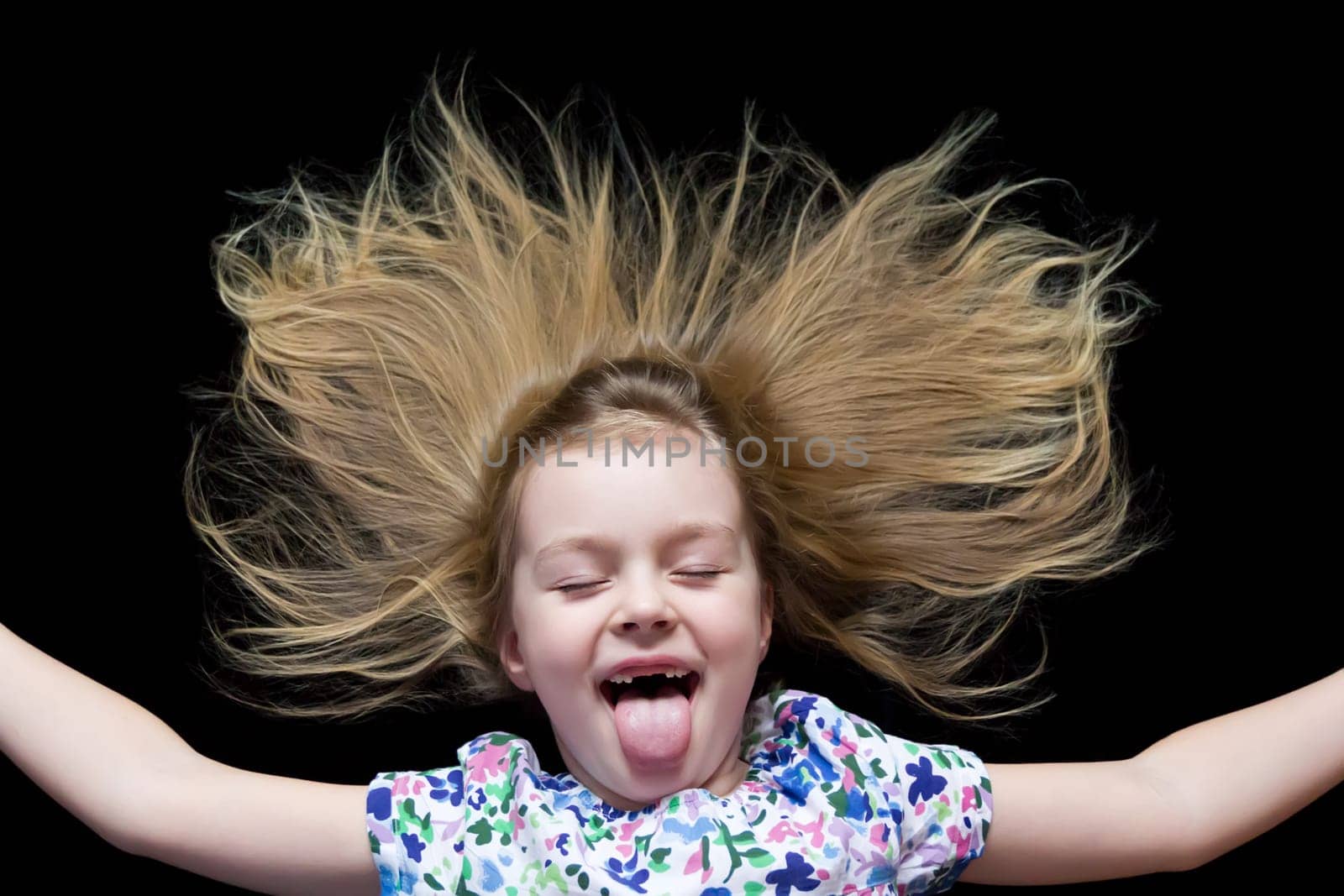 Girl makes faces imitate witch and put out tongue