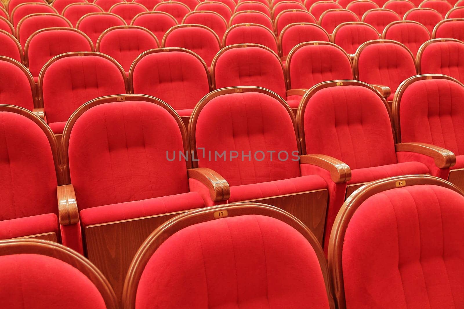Background of many red theatrical red chairs