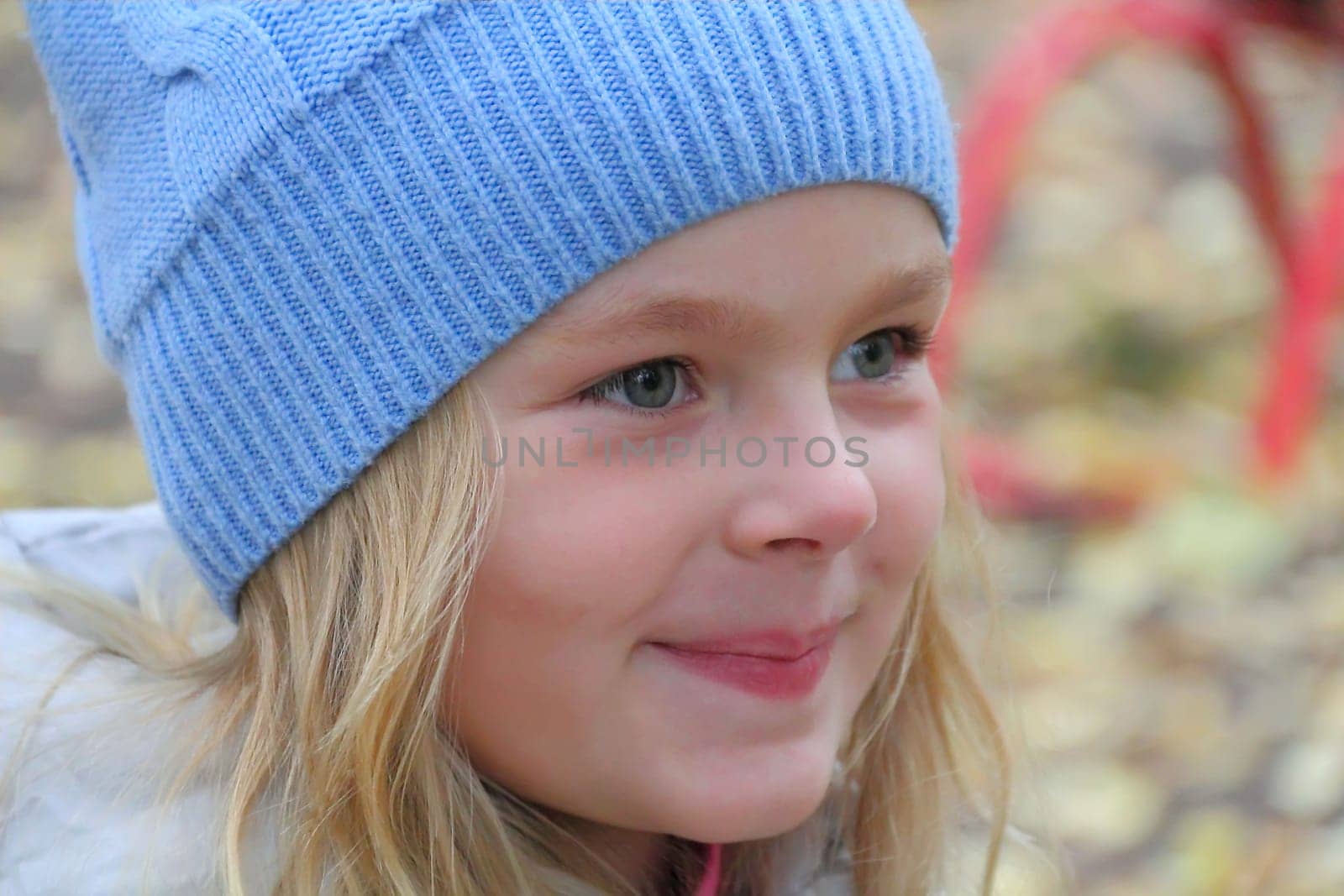 Portrait of beautiful girl with blond hair and blue eyes