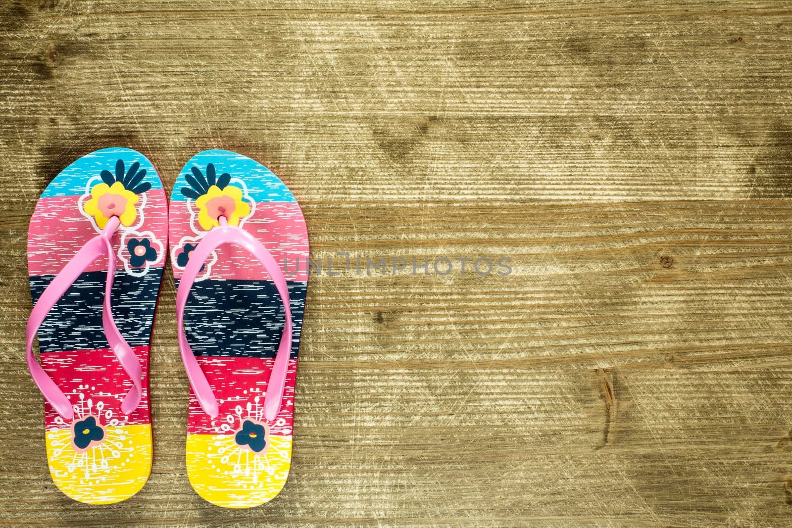 Flip flops on old wooden floor. Top view and copy space.