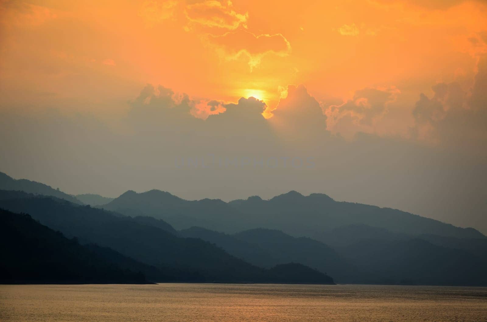 Beautiful landscape during sunset over a mountain ranges at lake in Srinakarin Dam, Kanchanaburi Province, Thailand