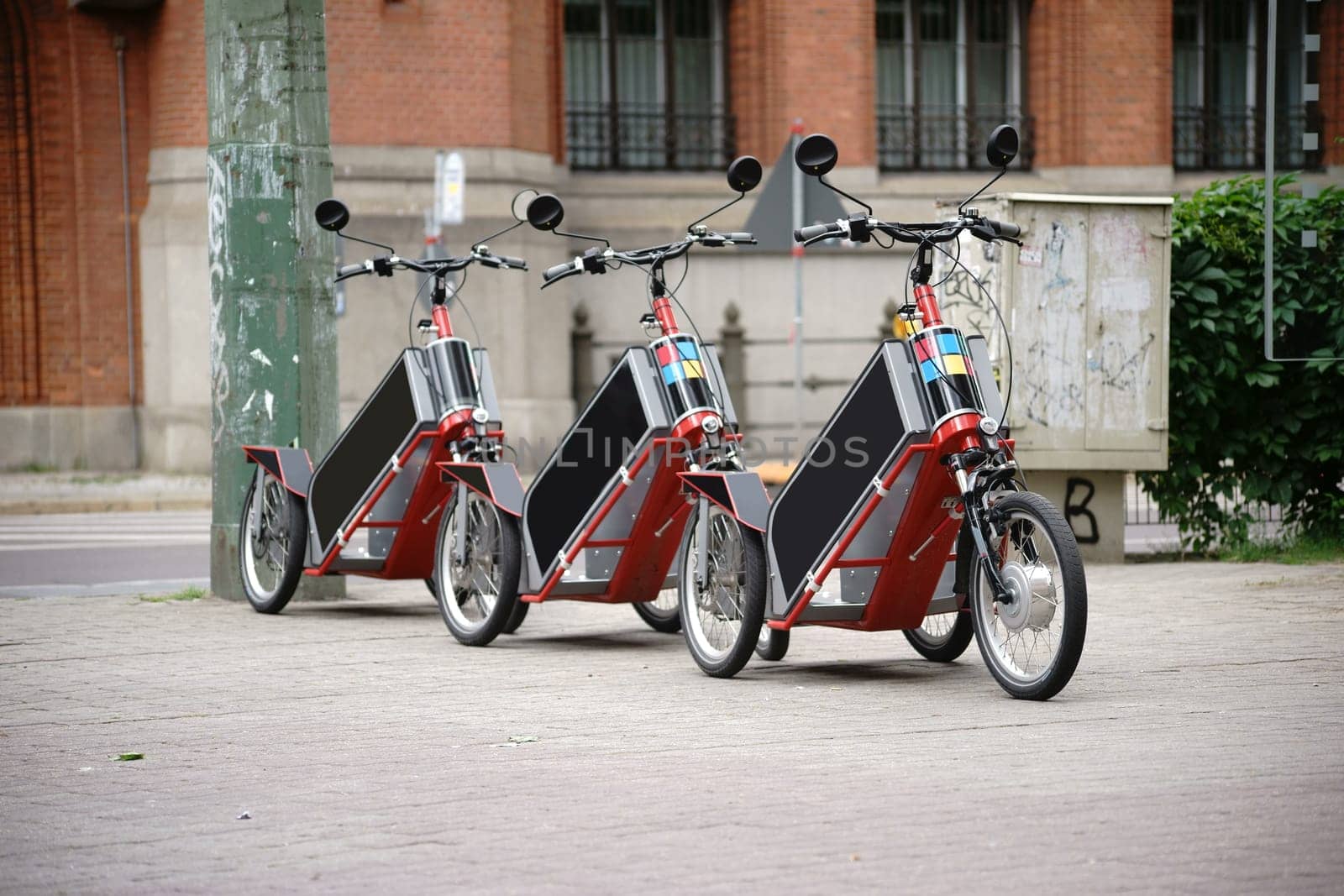 Bicycles or tricycles are lined up one after the other for rental.