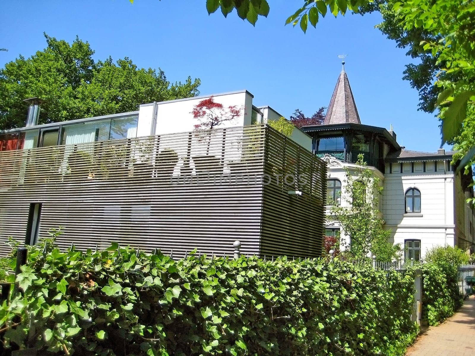 Hamburg, Germany - May 24, 2008: Villa in the district Blankenese, people on sightseeing trip through the mansion district.