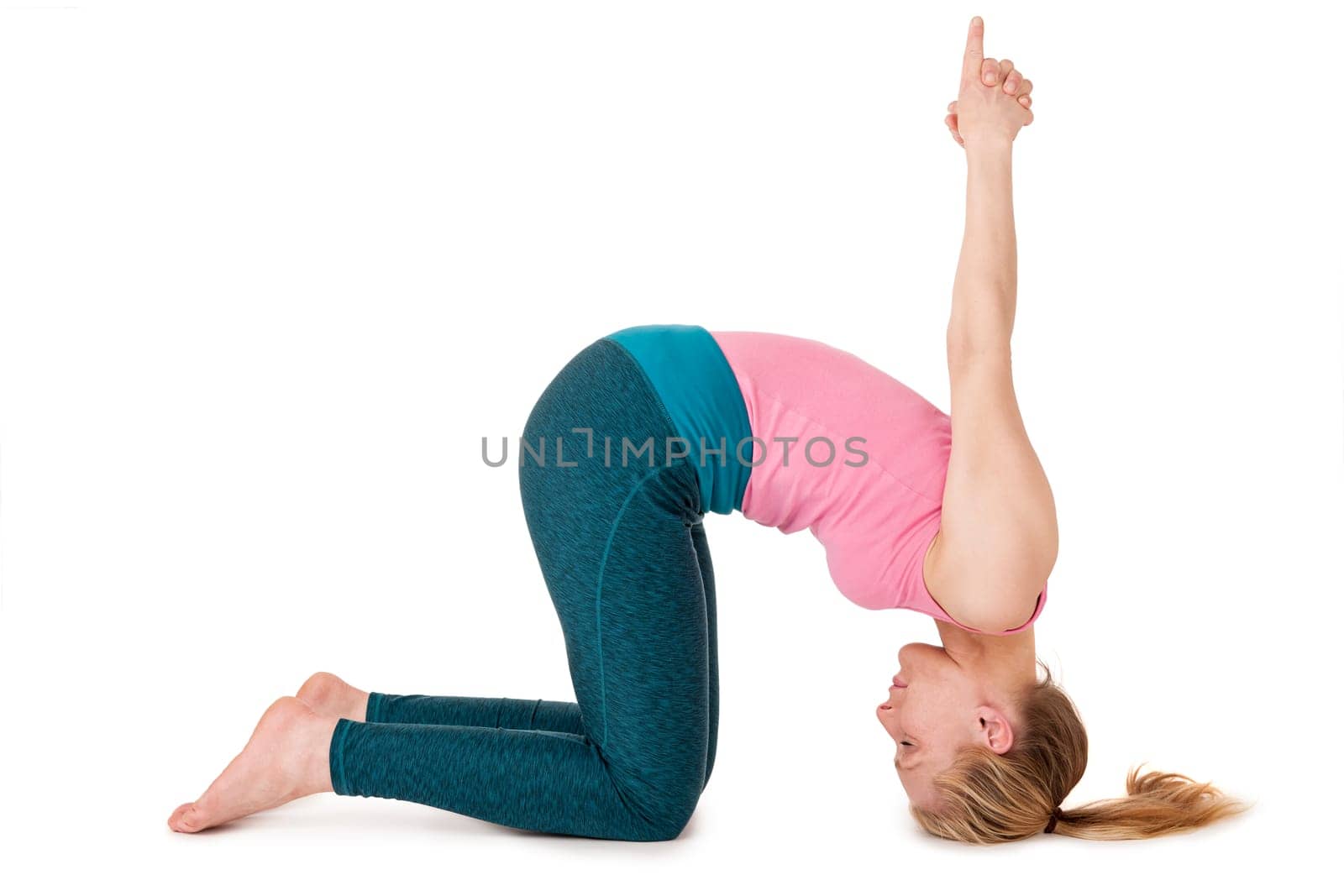Full body view of a young blonde woman doing yoga exercises against a white background with a slight shadow