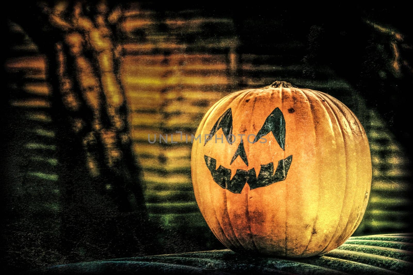 Large pumpkin with a scary face drawing on it