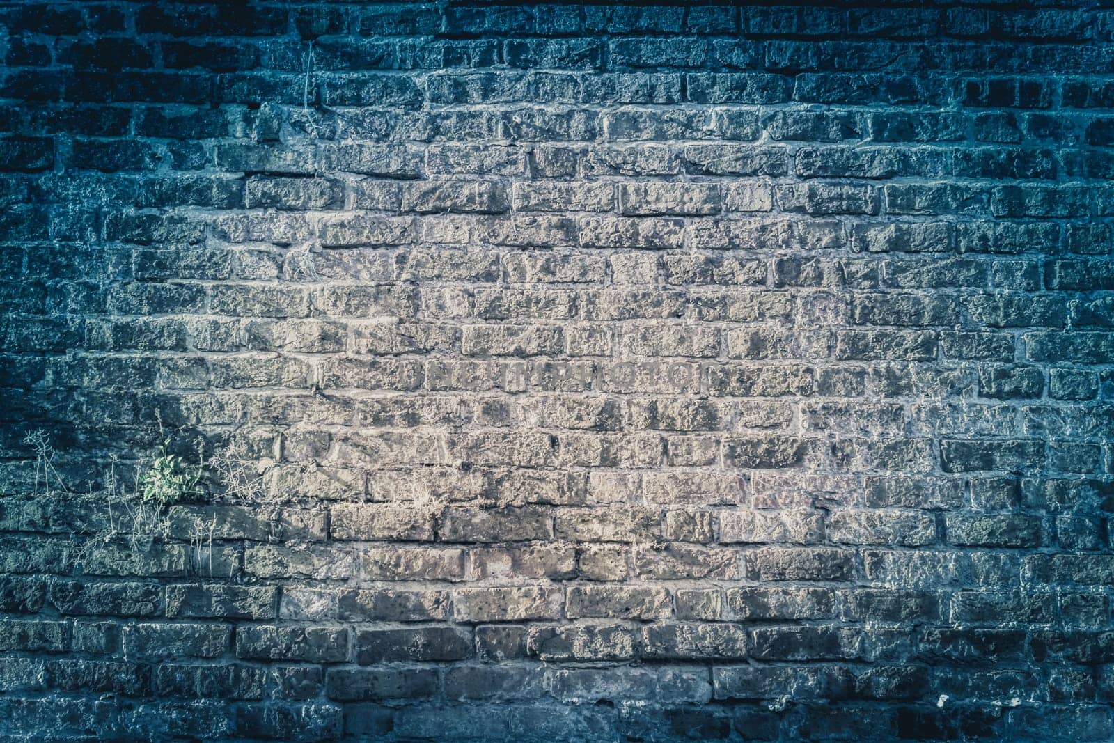 Dark blue grungy bricked wall textured background