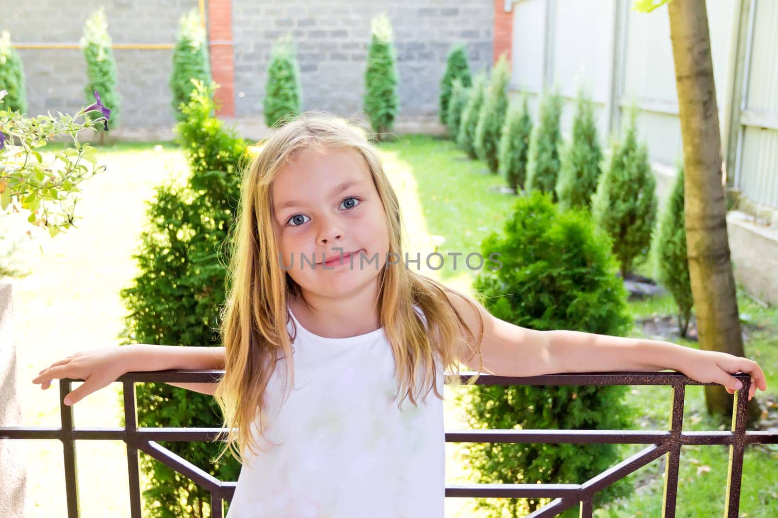 Cute girl with blond long hair and blue eyes