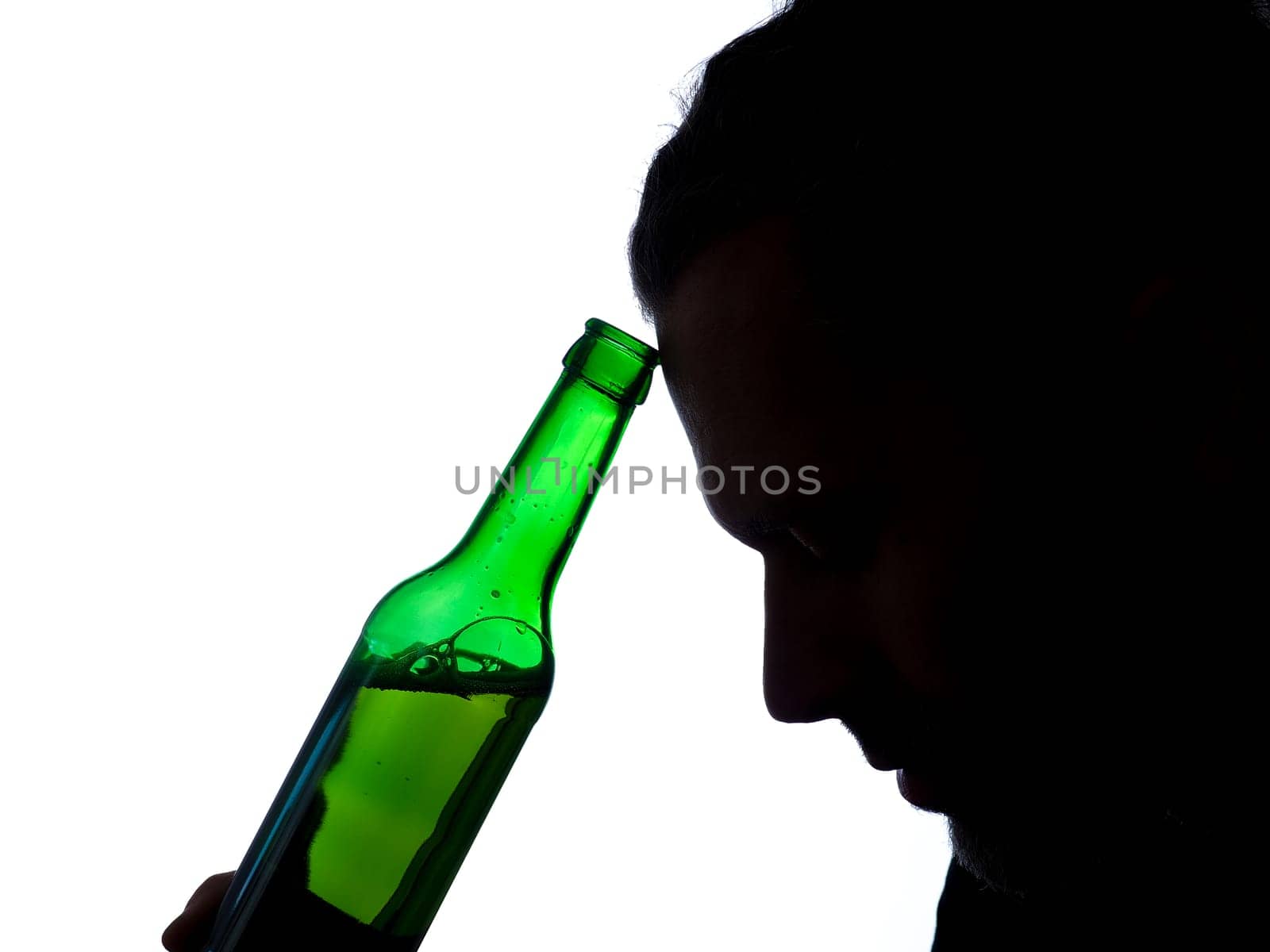 Silhouette of aman with a bottle of beer