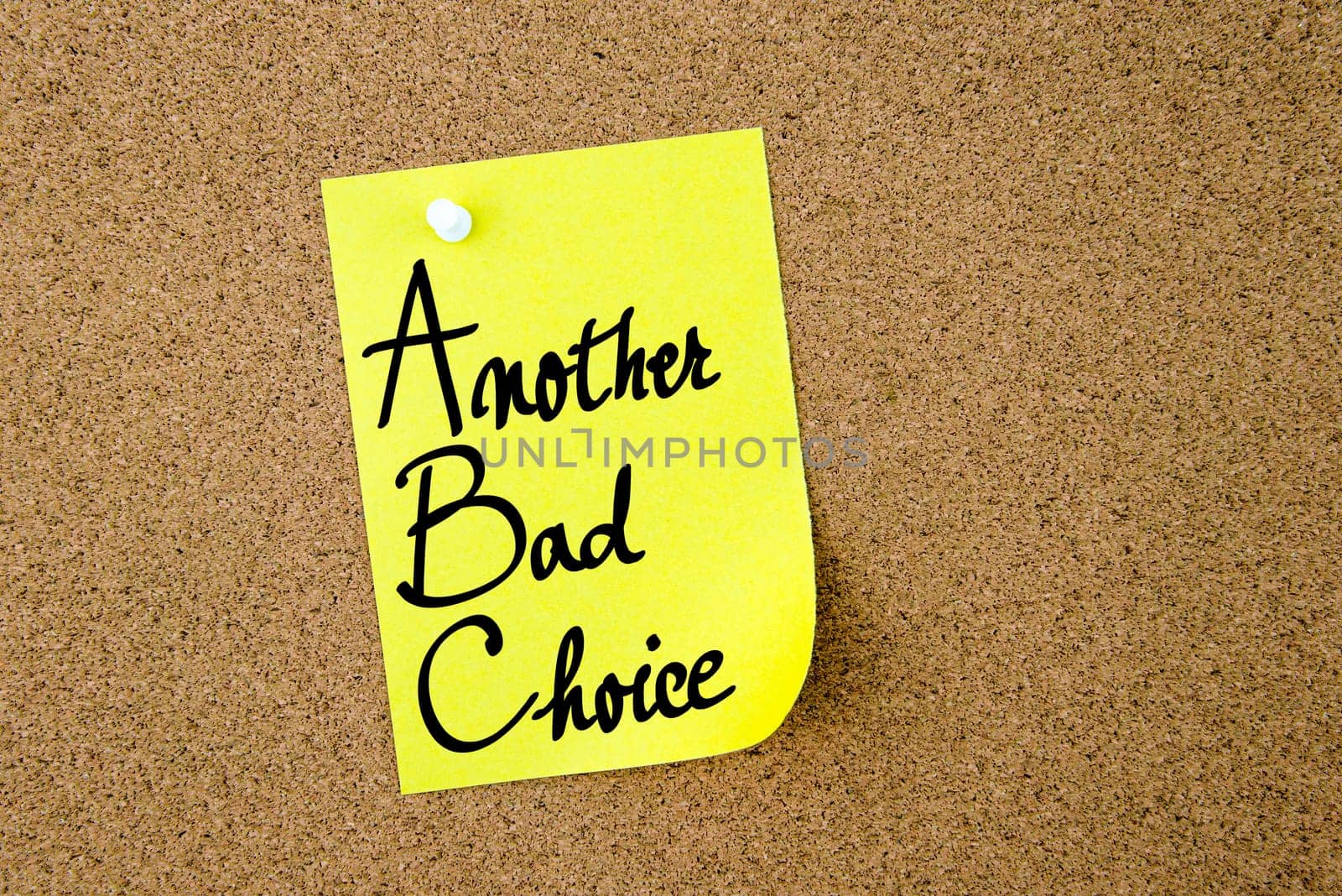 ABC Another Bad Choice written on yellow paper note pinned on cork board with white thumbtacks, copy space available