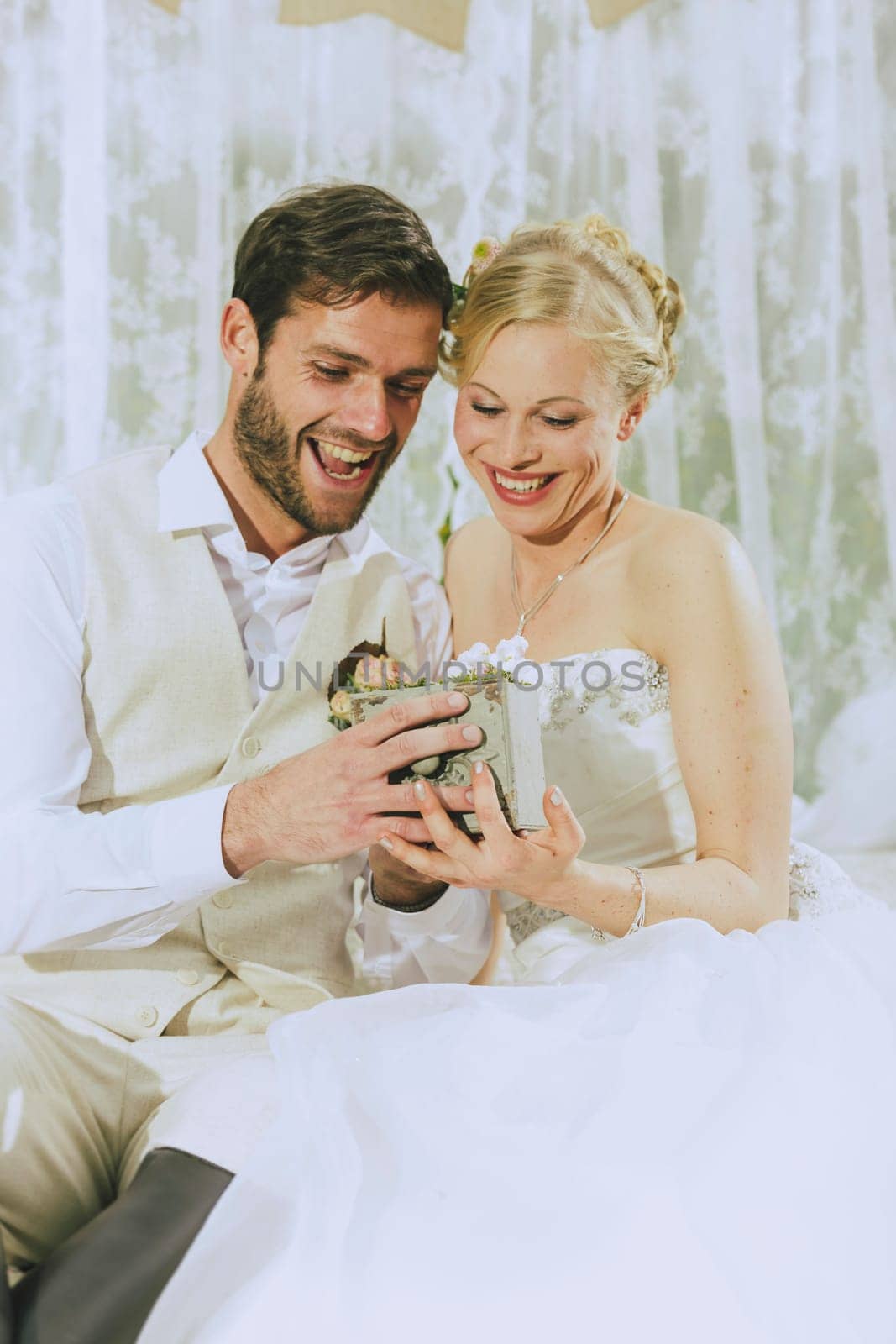 bride and groom see full joy of their wedding rings on and laugh