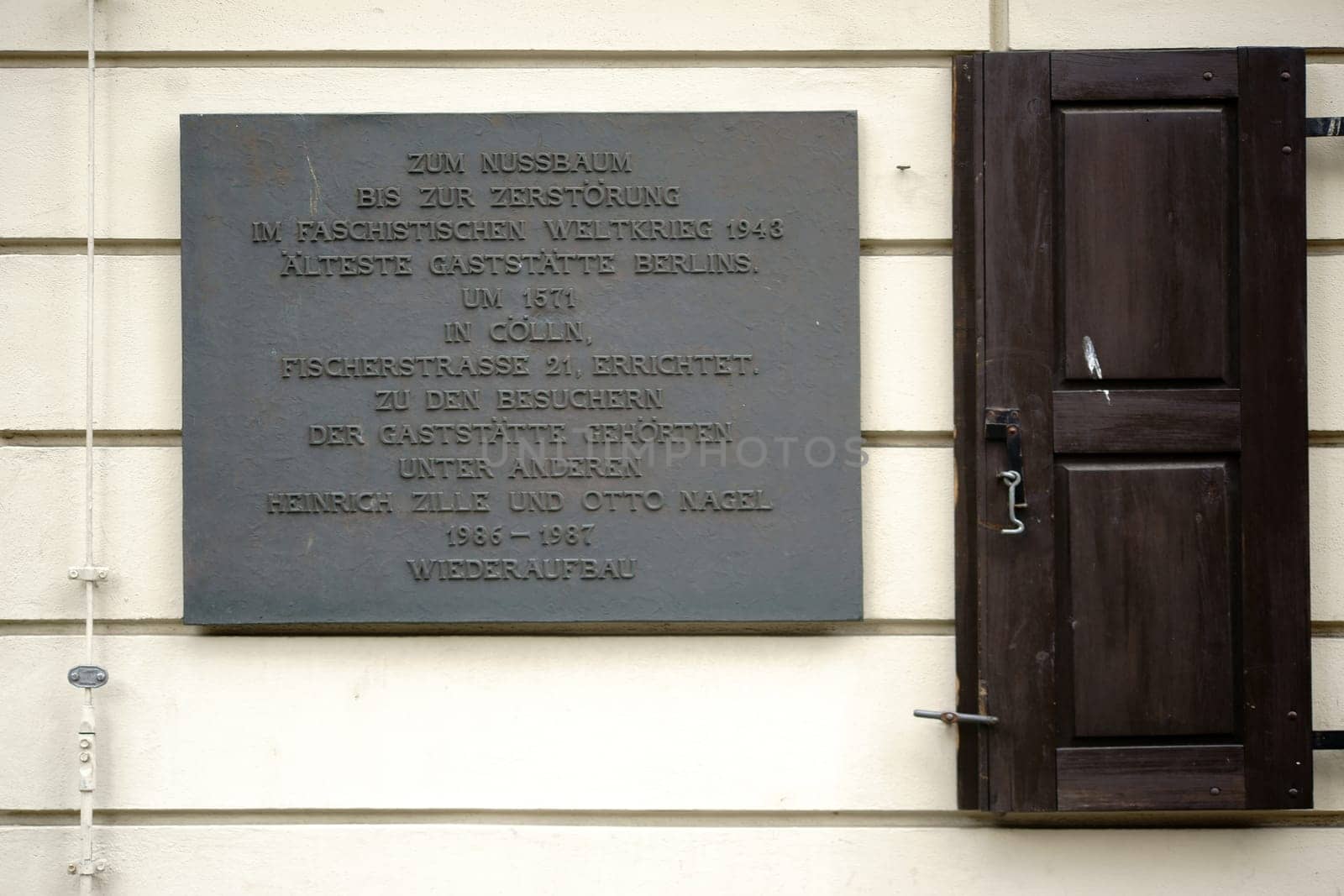 Berlin,Germany - June 21,2016: The memorial plaque of Berlin's oldest restaurant,Zum Nussbaum on a nostalgic façade in the Nikolaiviertel on June 21,2016 in Berlin.