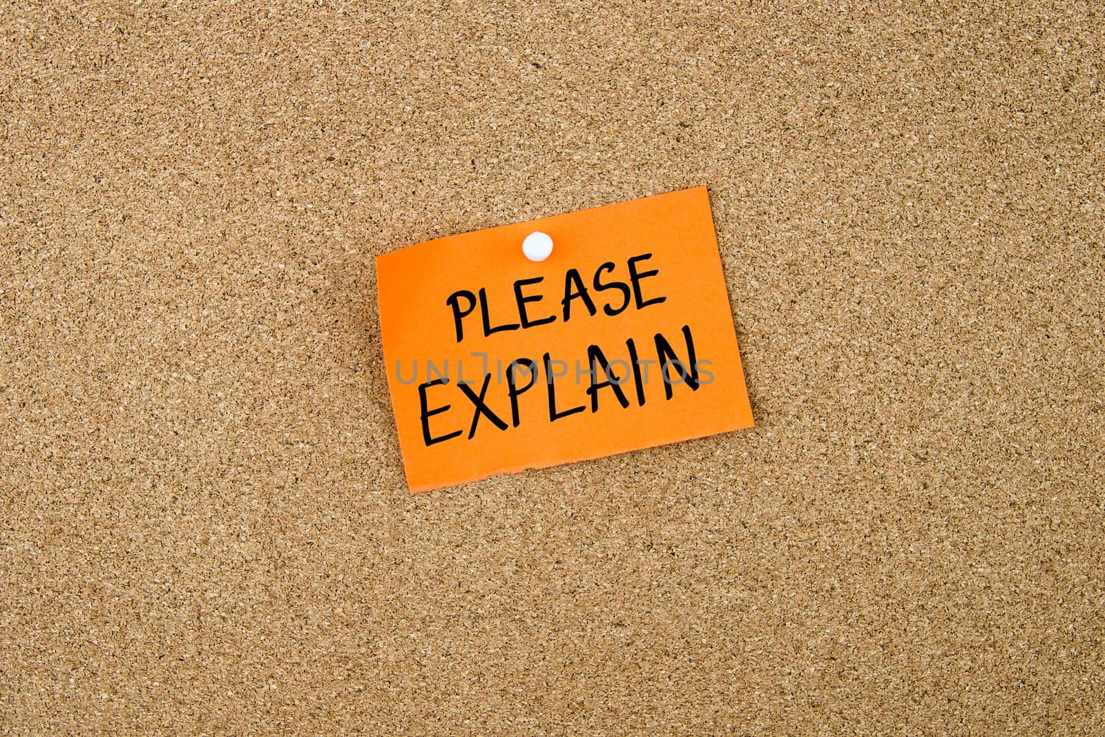 Please Explain written on orange paper note note pinned on cork board with white thumbtack, copy space available
