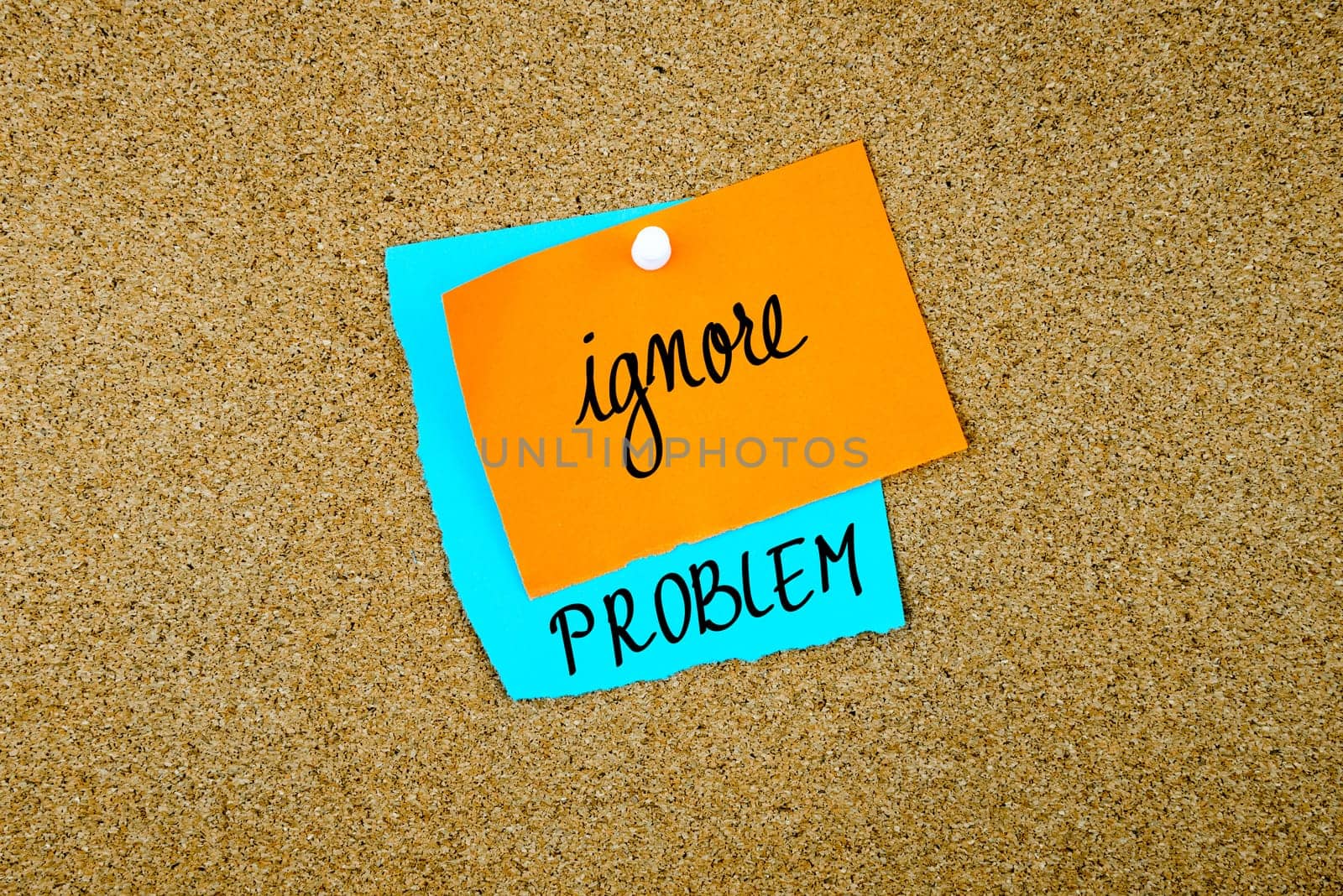 Ignore Problem written on paper notes pinned on cork board with white thumb tack, copy space available