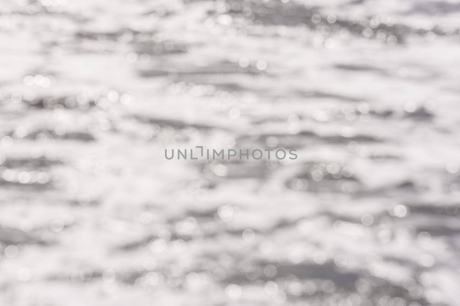 Background - blurred sea surface water with the reflection of sunlight