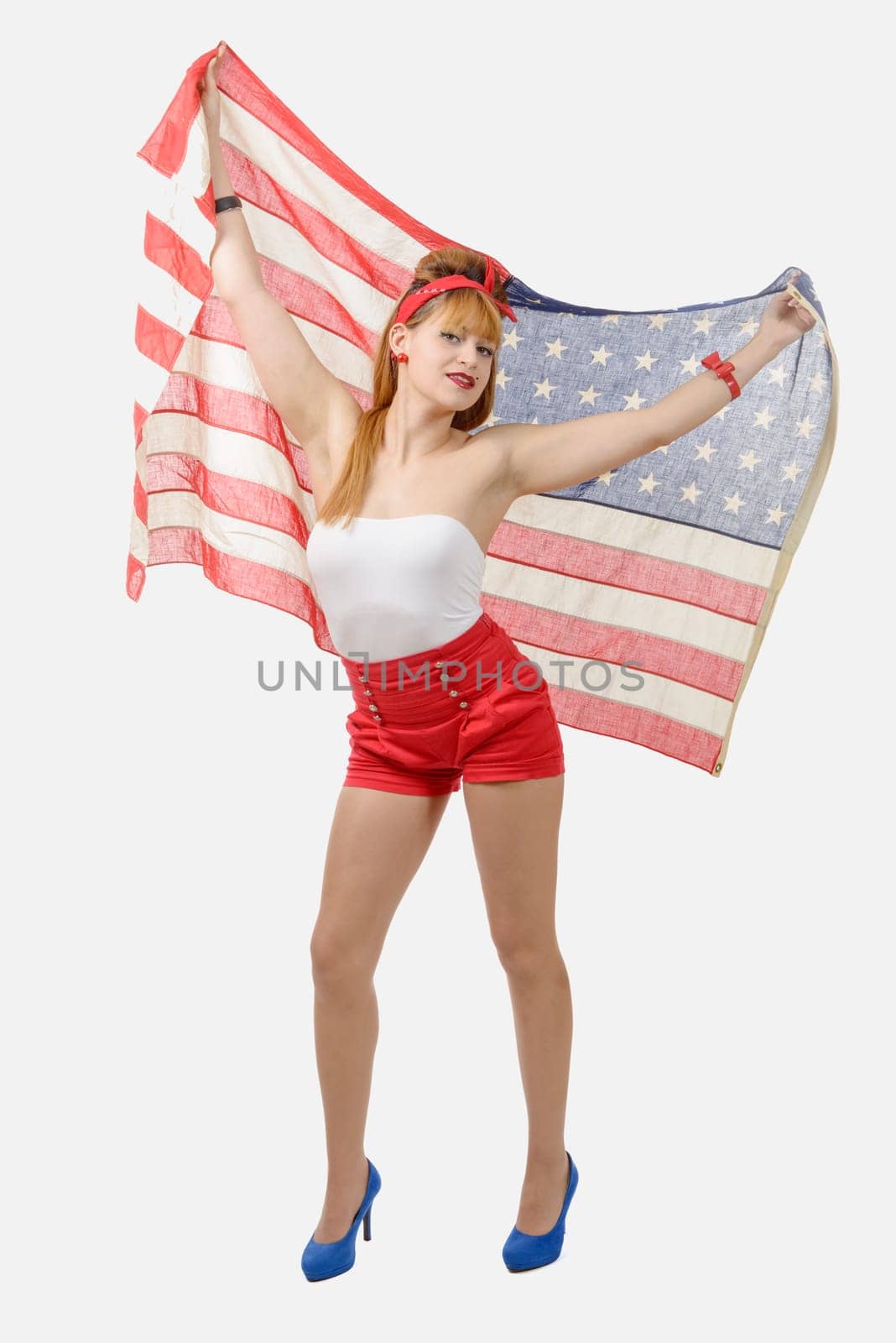 pretty young woman with an American flag isolated on white background