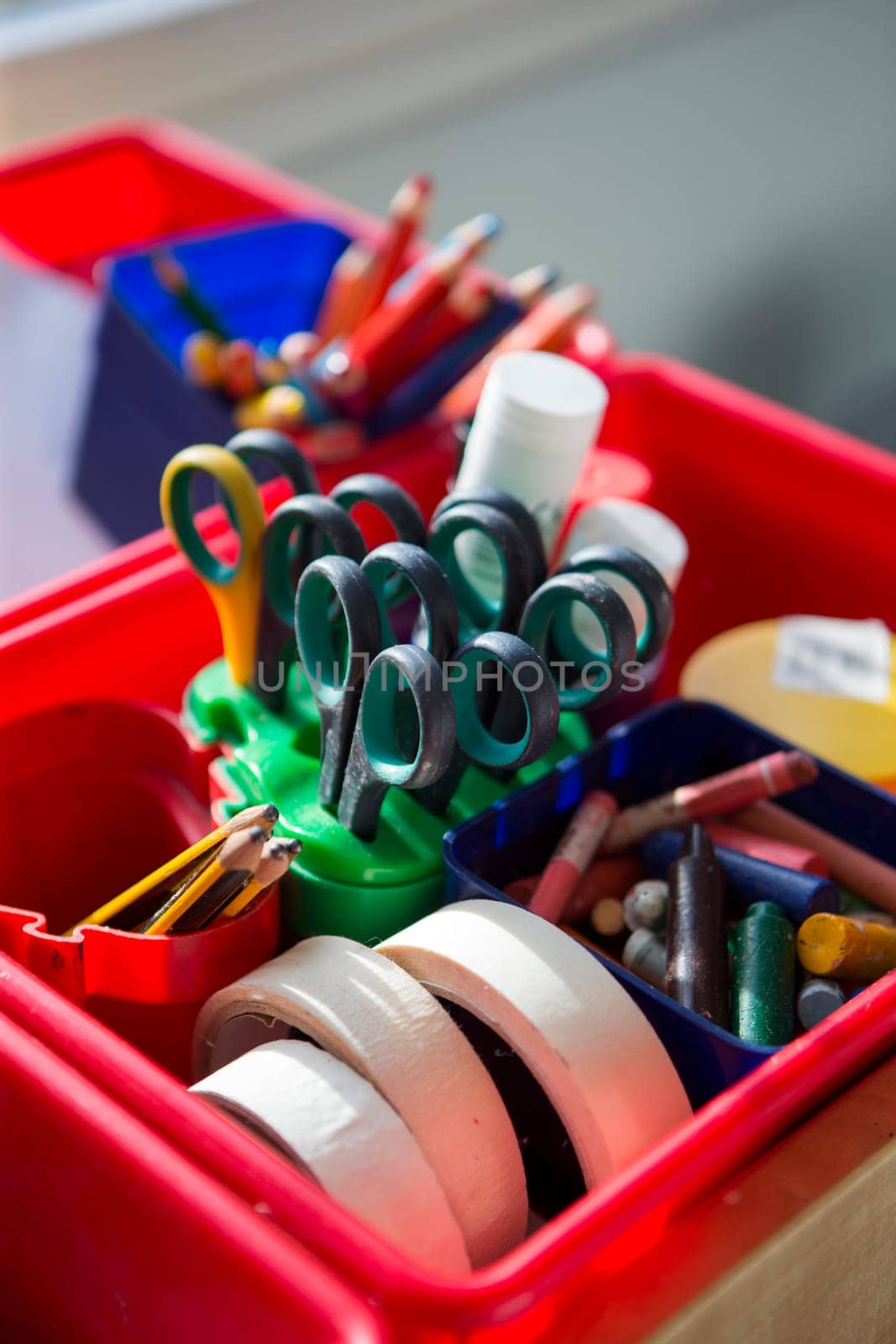 Close up of school equipment in a pot on a table.