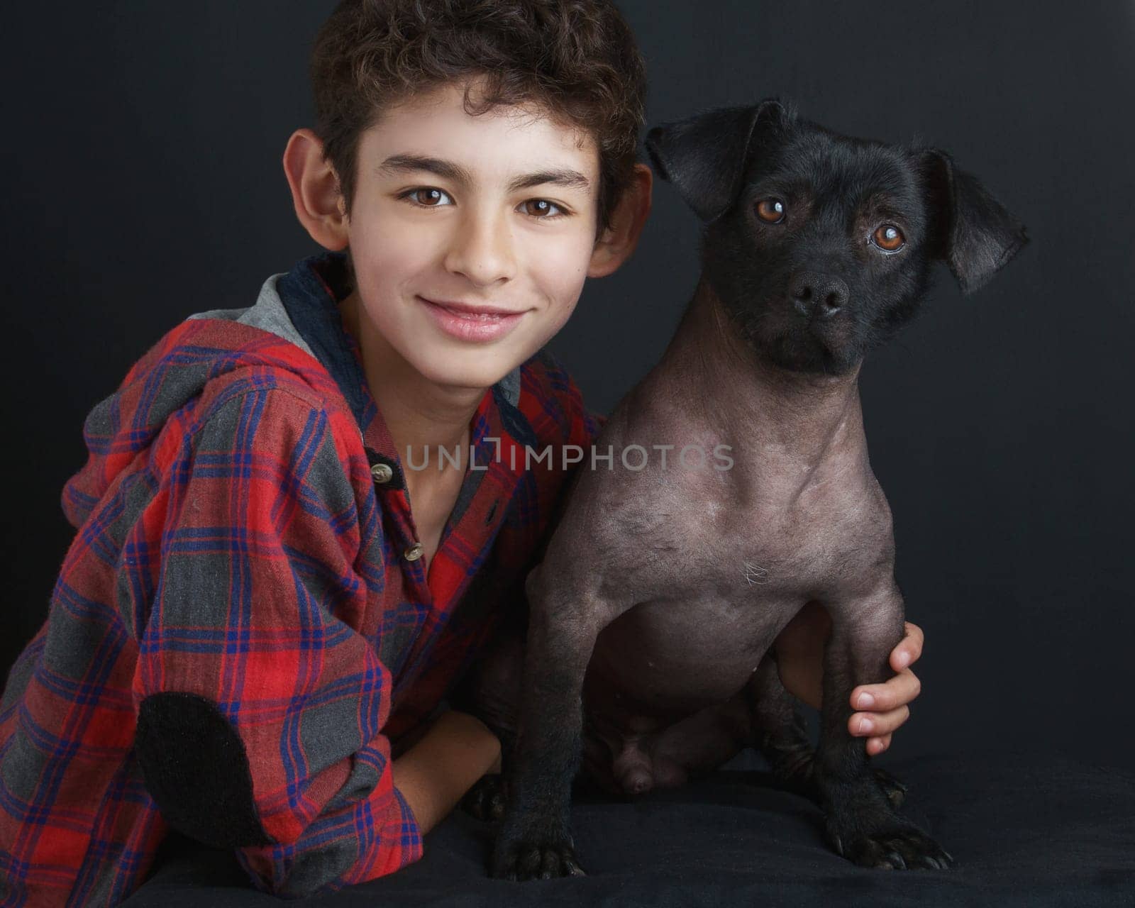 Portrait of Boy and Peruvian Dog on Black Background