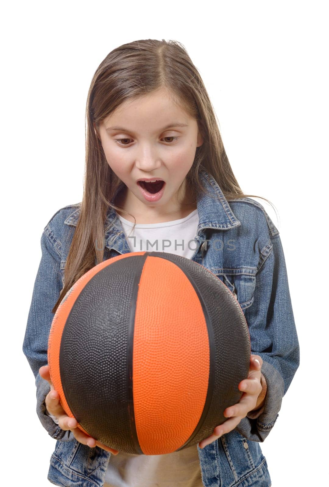 a preteen girl with a basketball isolated on white background
