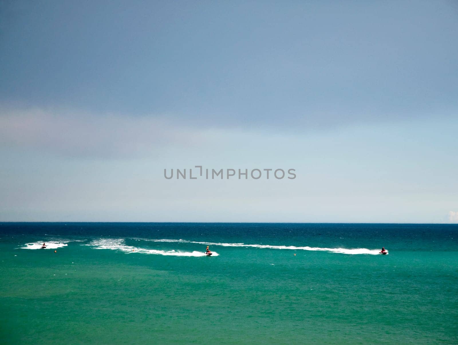 Three watercraft in a sea of bright colors