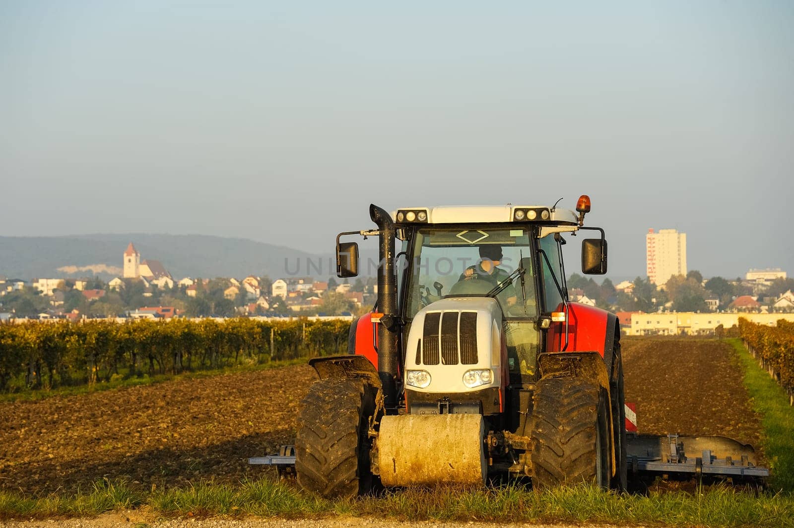 Tractor while harrowing in the field