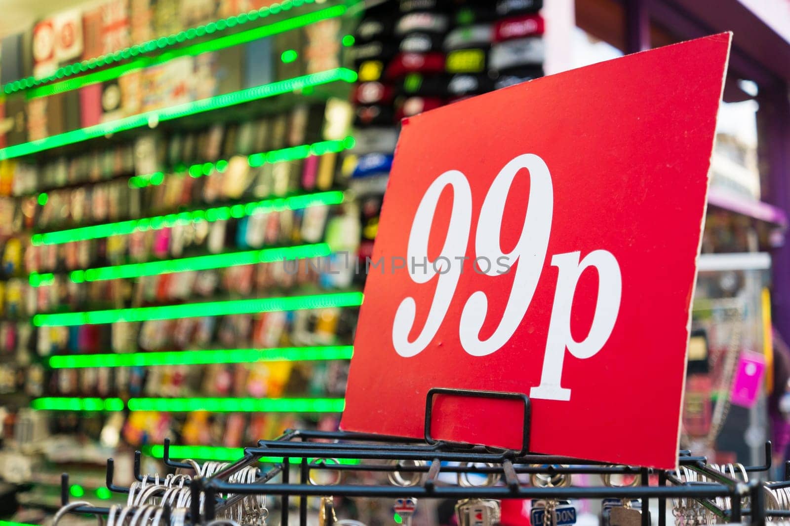 Detail of 99p sign with neon lights in the background