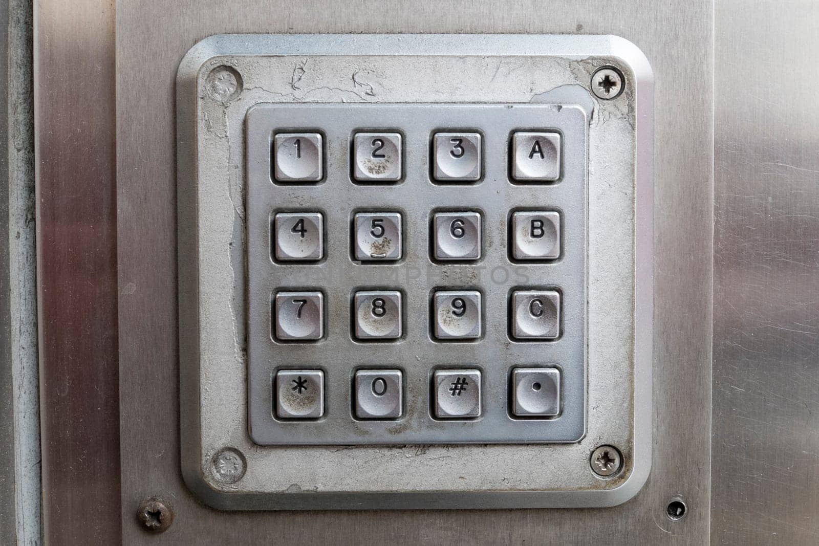 Detail shot of dirty metal number keypad