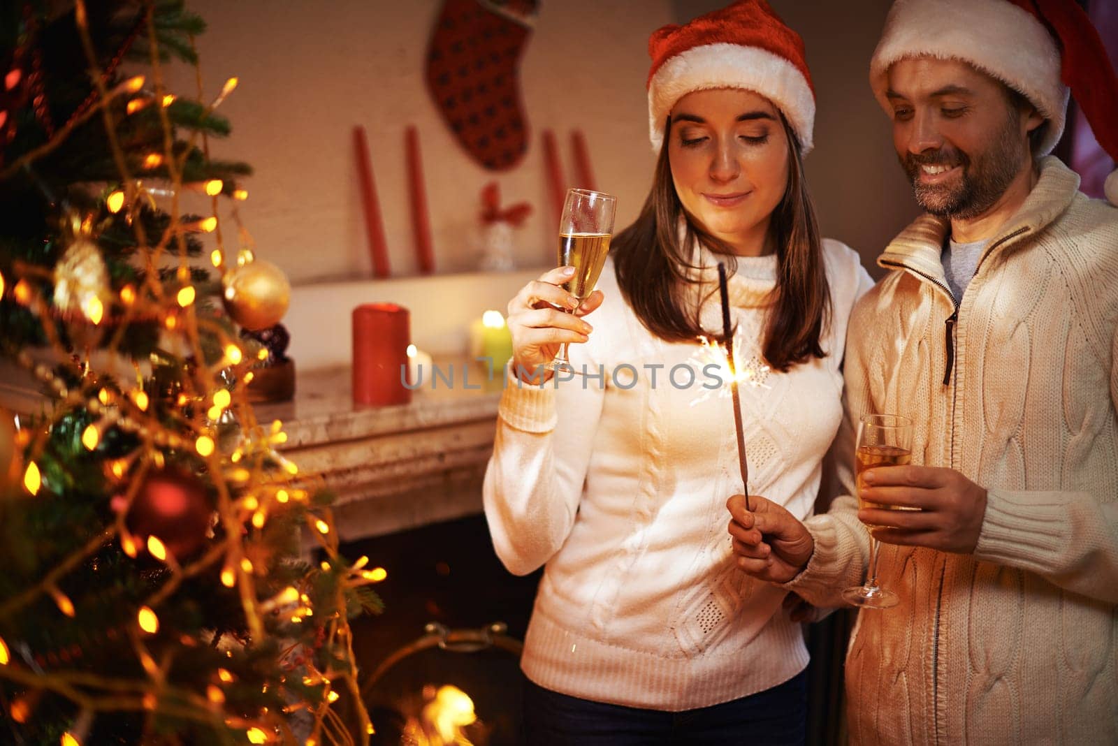 Santa man and woman with champagne looking at Bengal light on xmas night