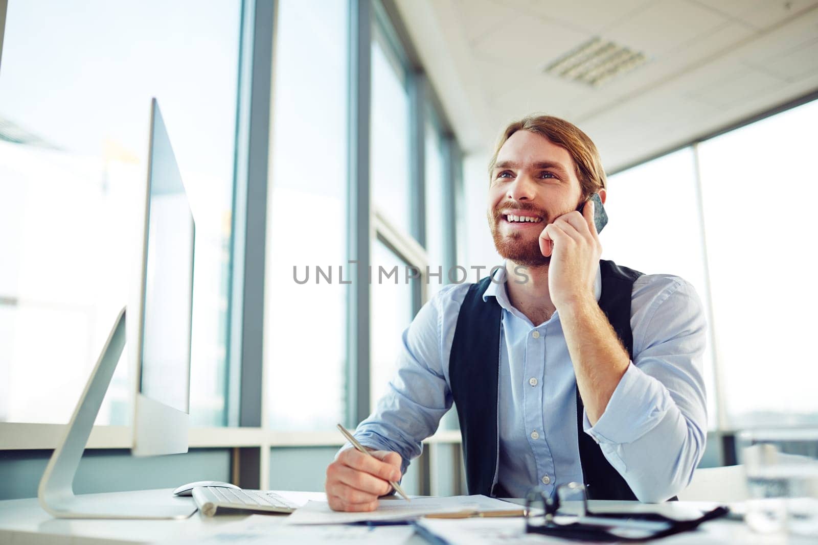 Smiling consultant speaking on the phone in office