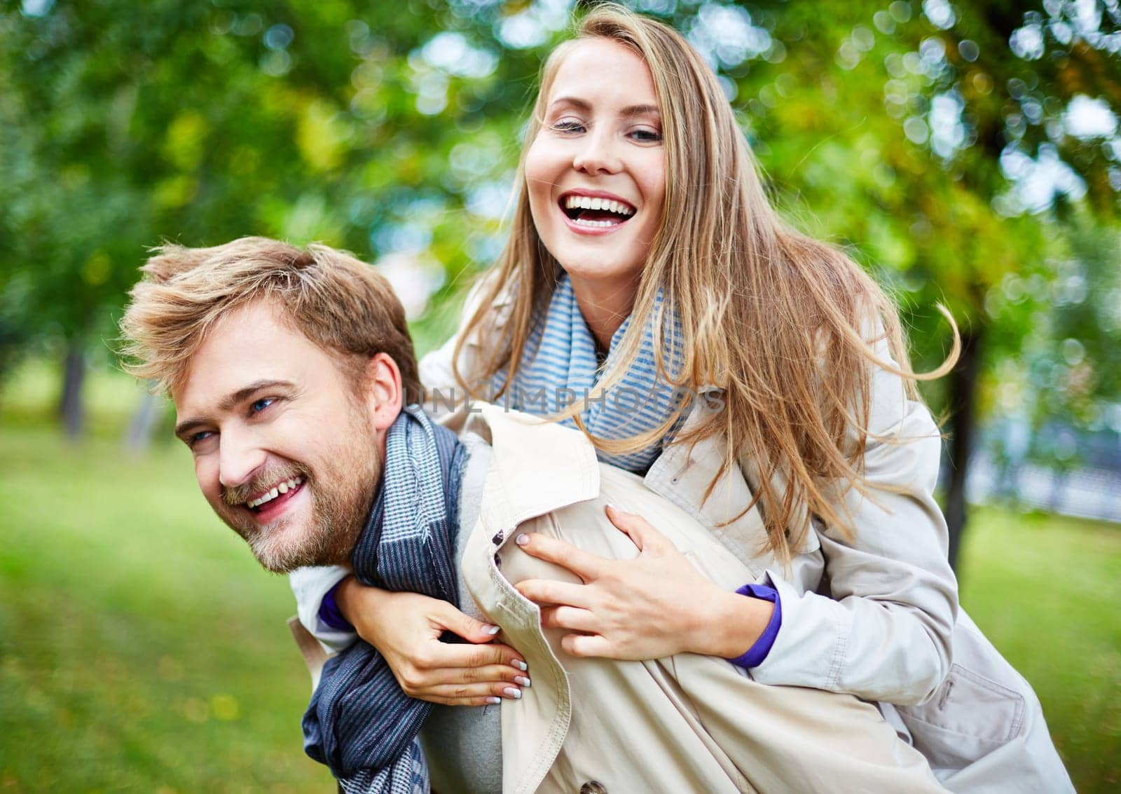 Ecstatic young couple having fun in park