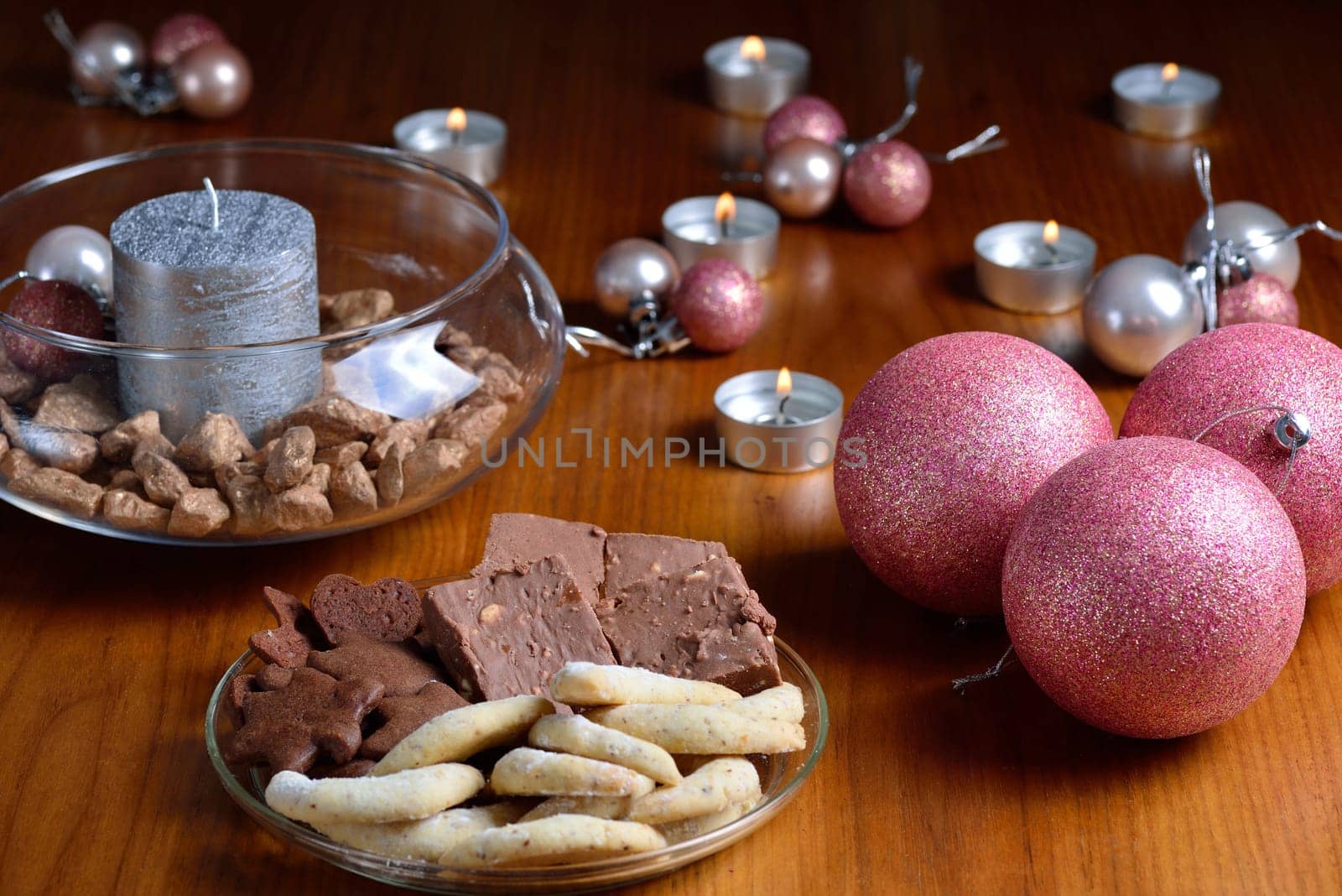 Christmas decoration with christmas bulbs, candles and cookies
