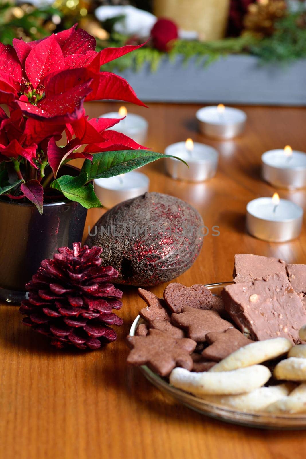 Christmas decoration with poinsettia, cookies and candles