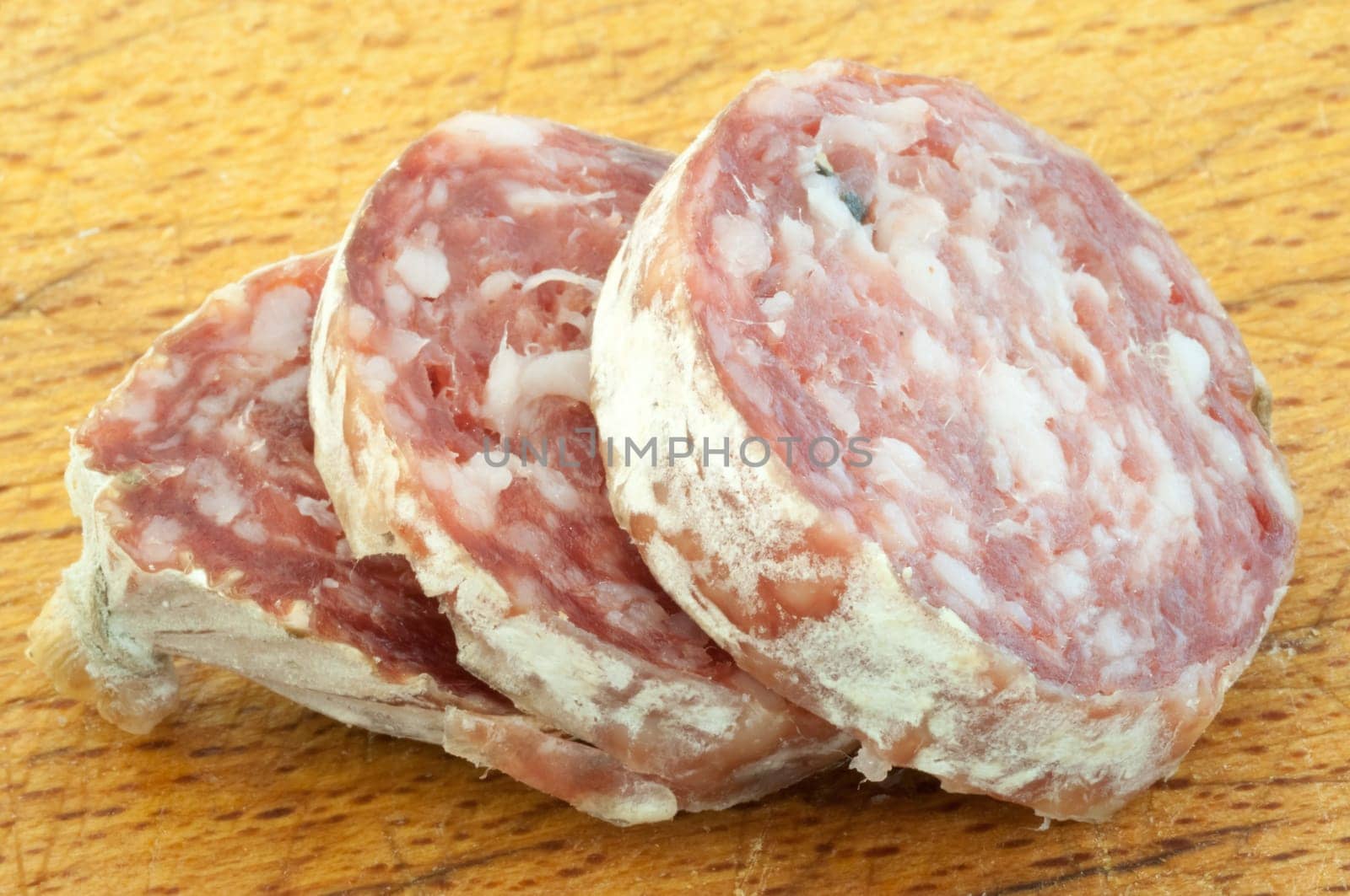 beautiful background of salami cutted with a wood background