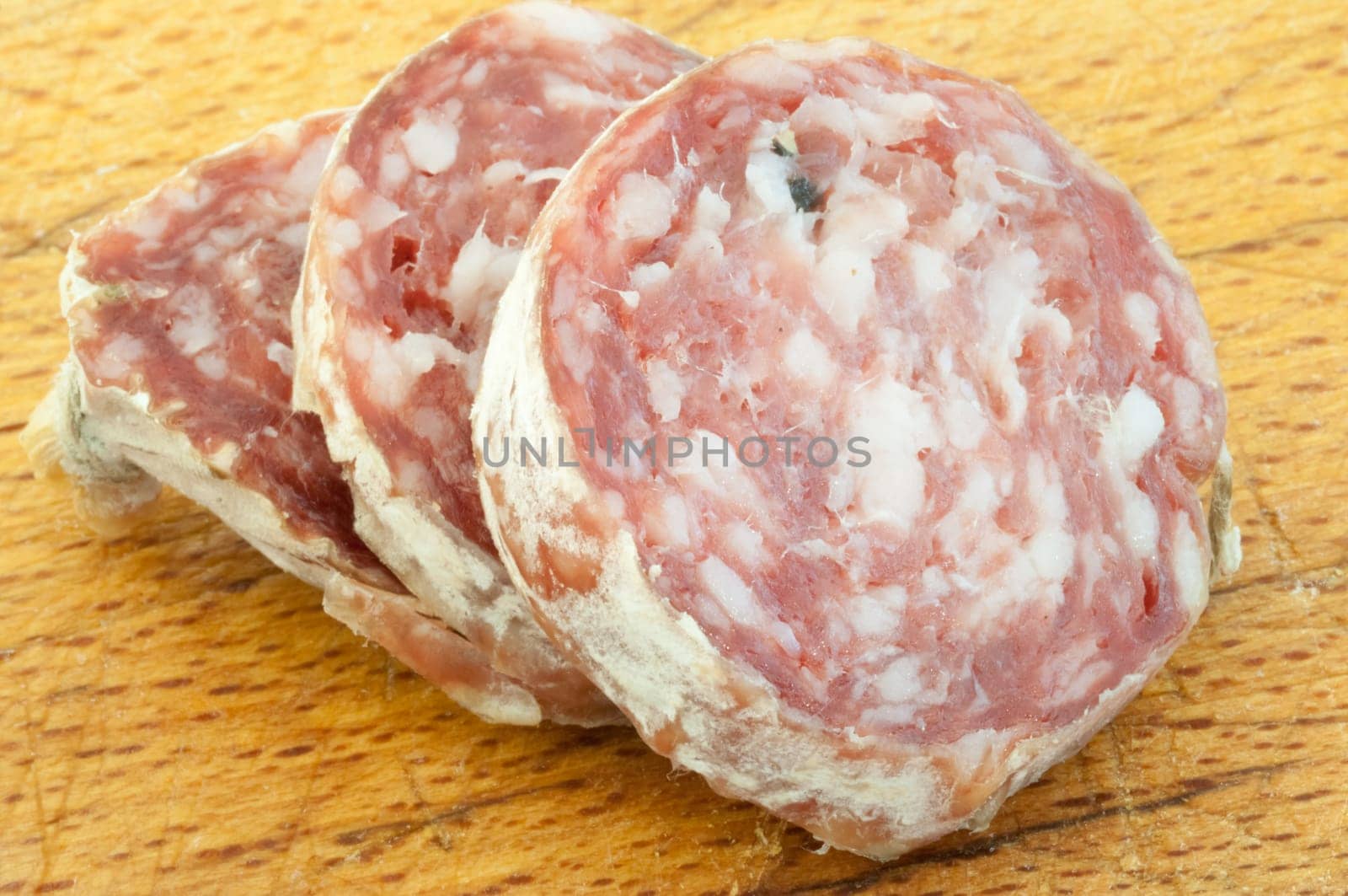 beautiful background of salami cutted with a wood background