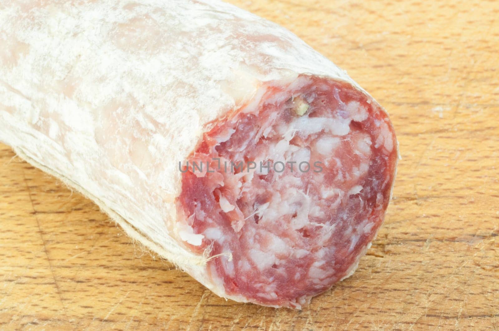 beautiful background of salami cutted with a wood background