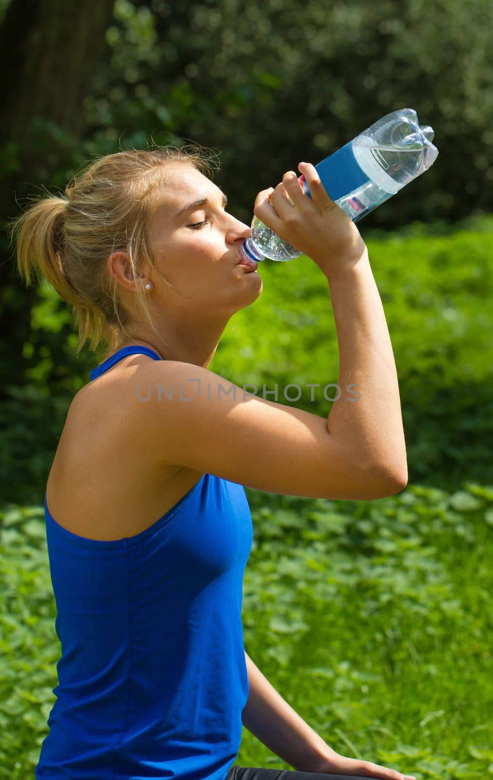Young woman drinking after sport