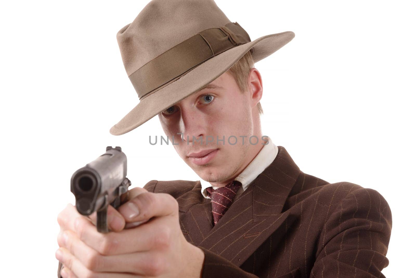 gangster in a suit vintage, aim with a gun on white
