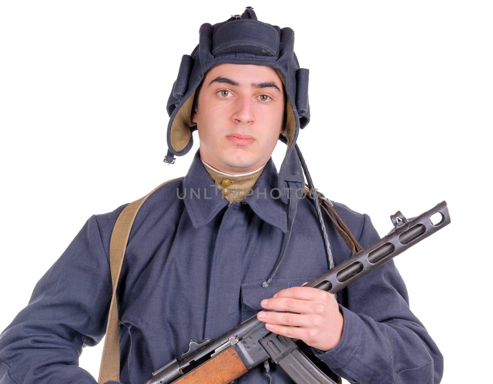young Soviet pilot of tank with machine gun on white background