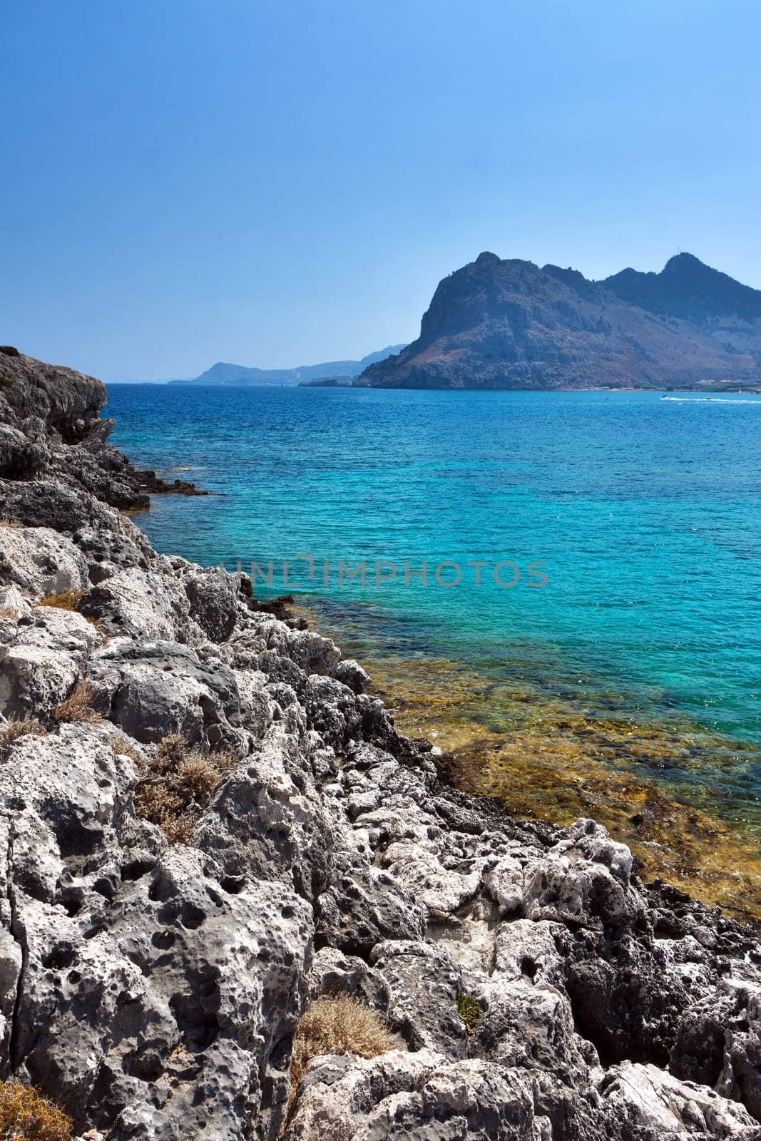 Kolymbia beach with the rocky coast in Greece.