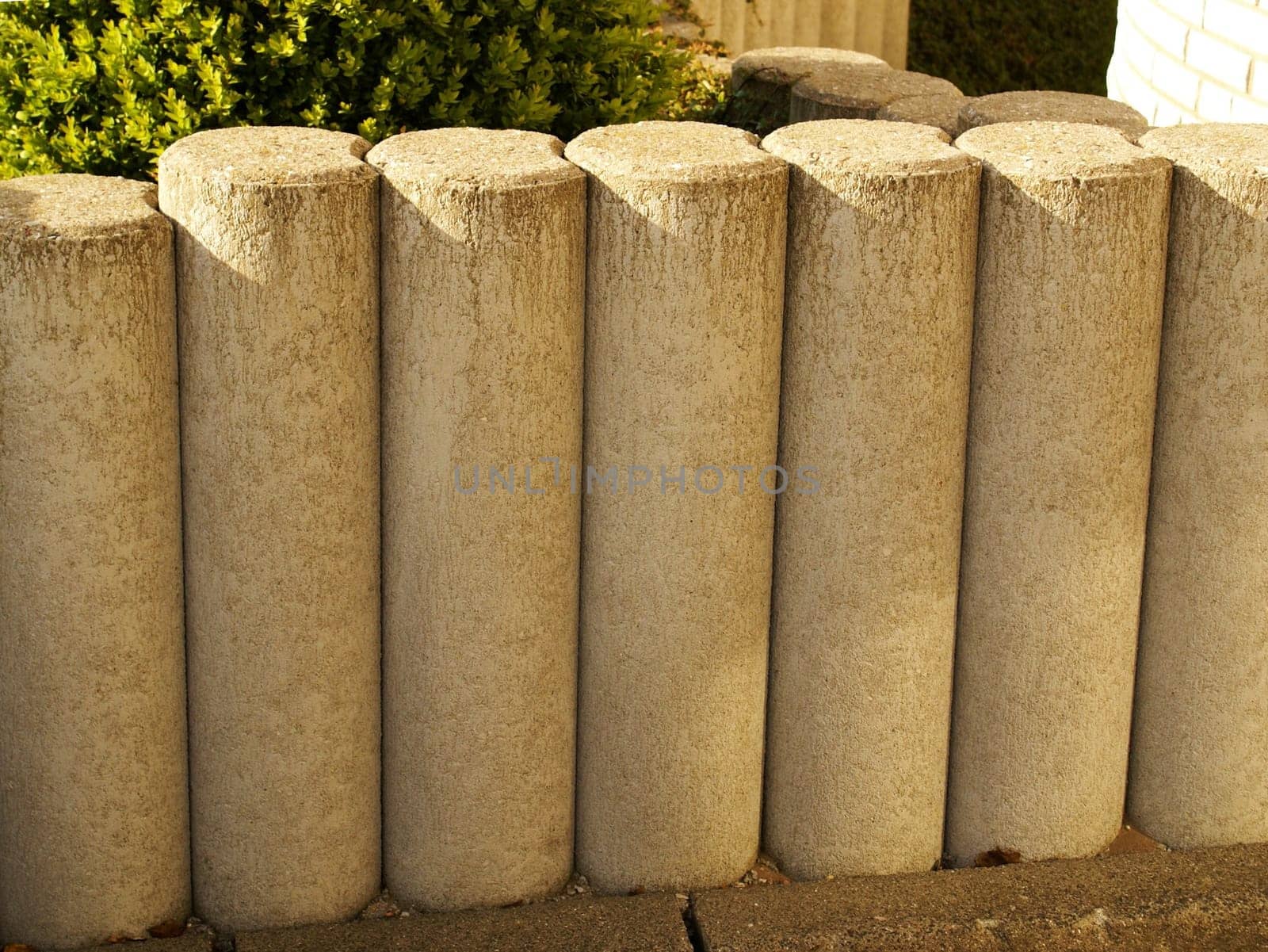 Stone palisade fence in front of a house