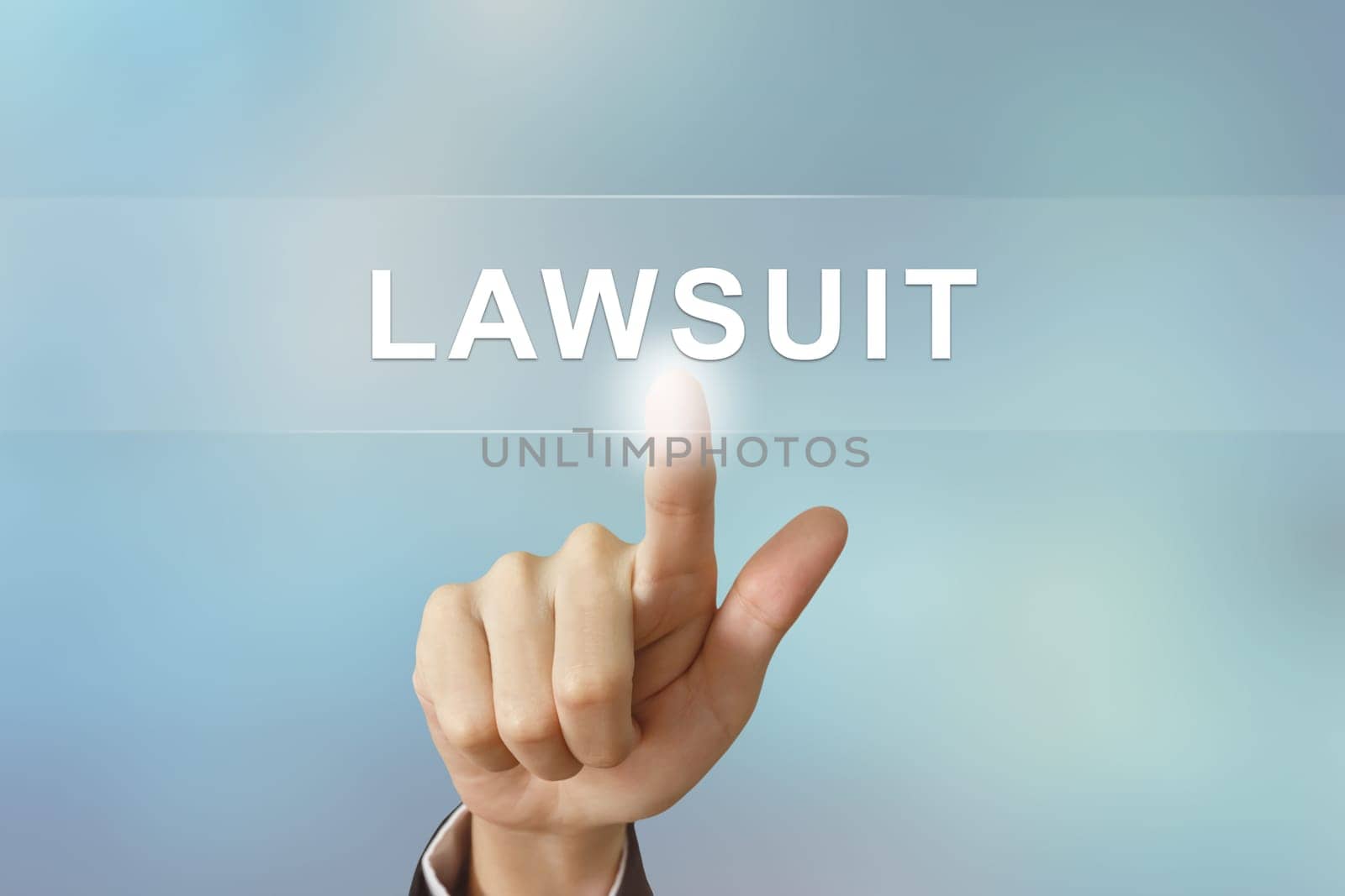 business hand pushing lawsuit button on blurred background