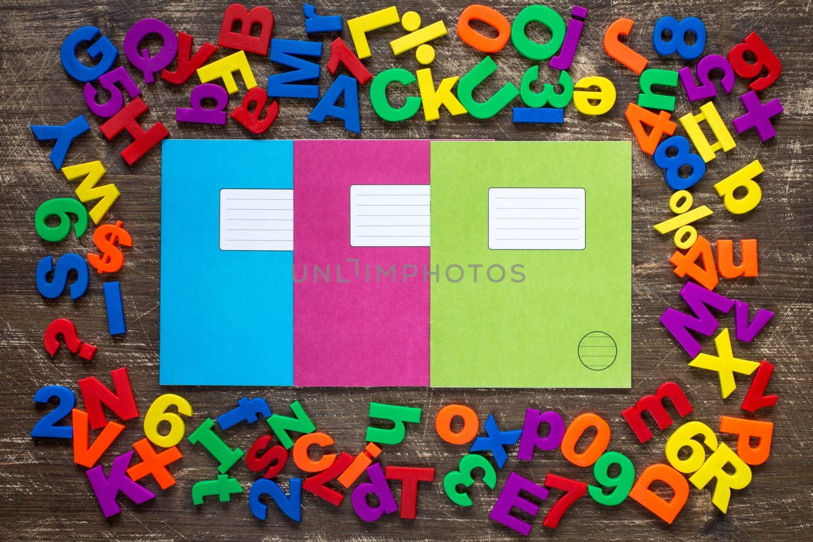 Three exercise books and border of colorful letters and numbers