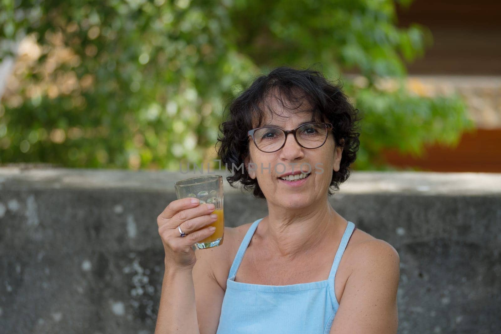 a middle-aged woman drinking orange juice