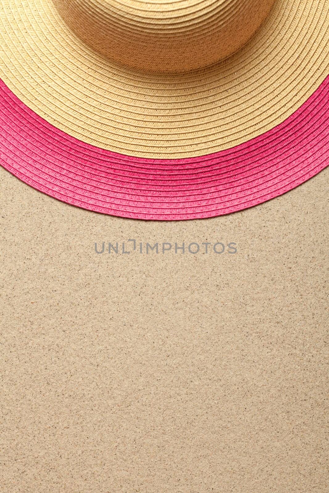 Sandy beach background with straw hat. Summer concept. Top view